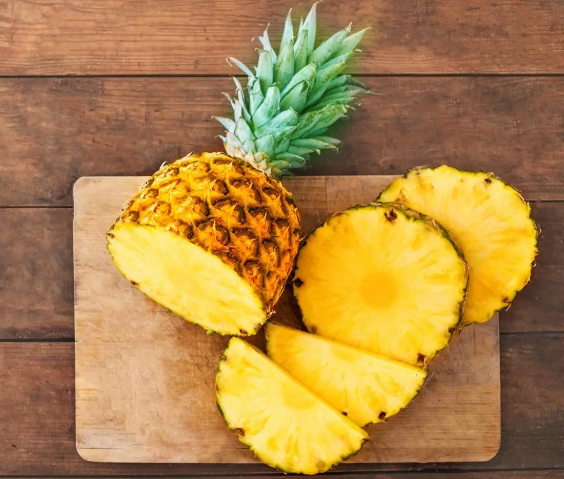 fresh-pineapple-sliced-on-chopping-board.webp